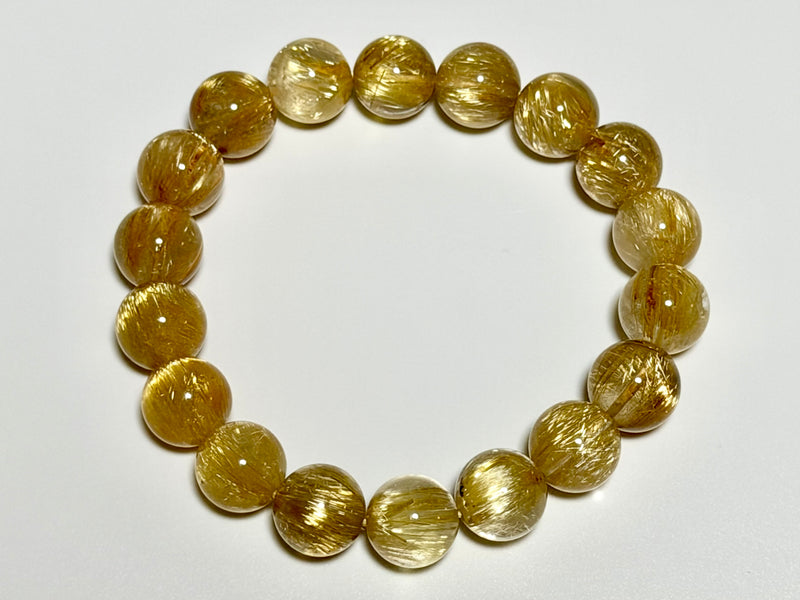 Cat’s-Eye Venus Hair Rutilated Quartz bracelet, 11–11.5 mm, top view showing chatoyant bands and bead arrangement.