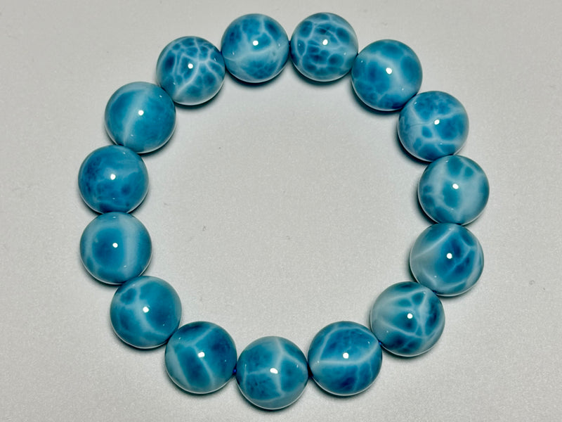 Larimar bracelet, 14–14.5 mm, top view showing blue color, white marbling, and bead arrangement.