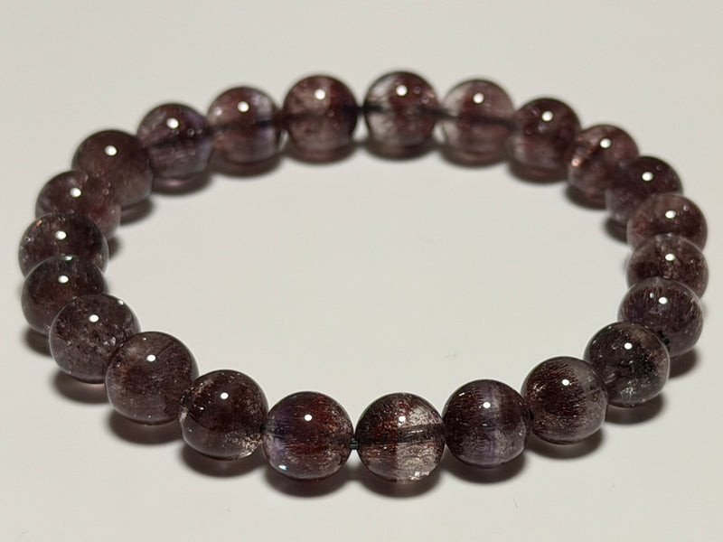 Hanabi Super Seven Quartz bracelet, 8–8.5 mm, full view showing reddish-purple inclusions.