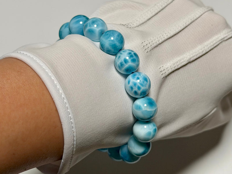 Larimar bracelet, 12 mm, angled view showing translucency and natural patterning.