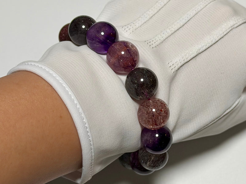Super Seven Quartz bracelet, 15–15.5 mm, angled view showing quartz translucency and natural inclusions.