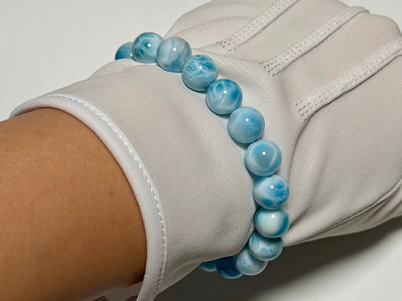 Larimar bracelet, 9.8 mm, close-up showing blue color, white marbling, and translucency.