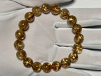 Taichin Golden Rutilated Quartz bracelet, 10 mm, gloved-hand view showing thick gold rutile needles.